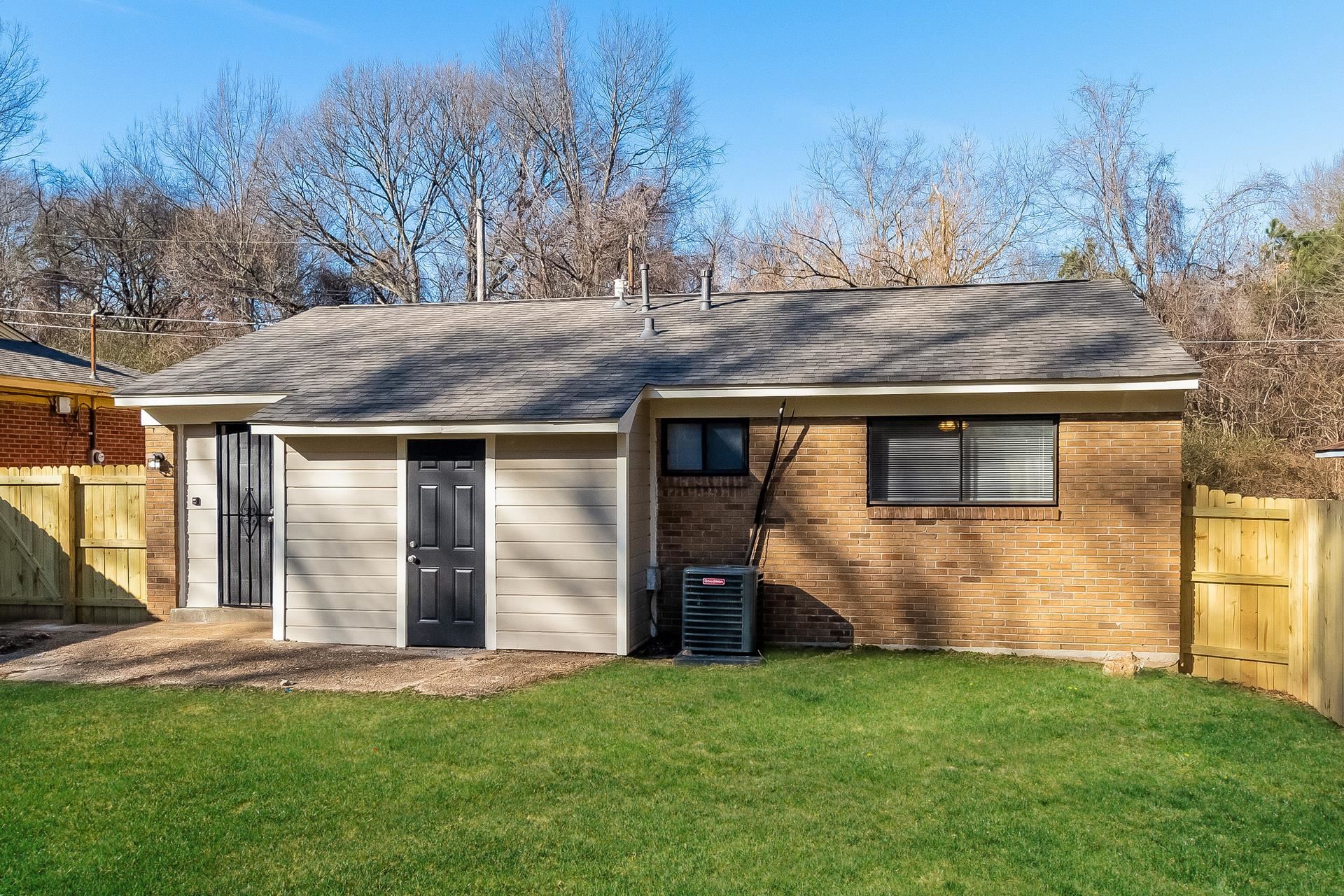 453 Charter Avenue Memphis, TN 38109 - Photo 15 of 16 a view of a house with backyard and trees