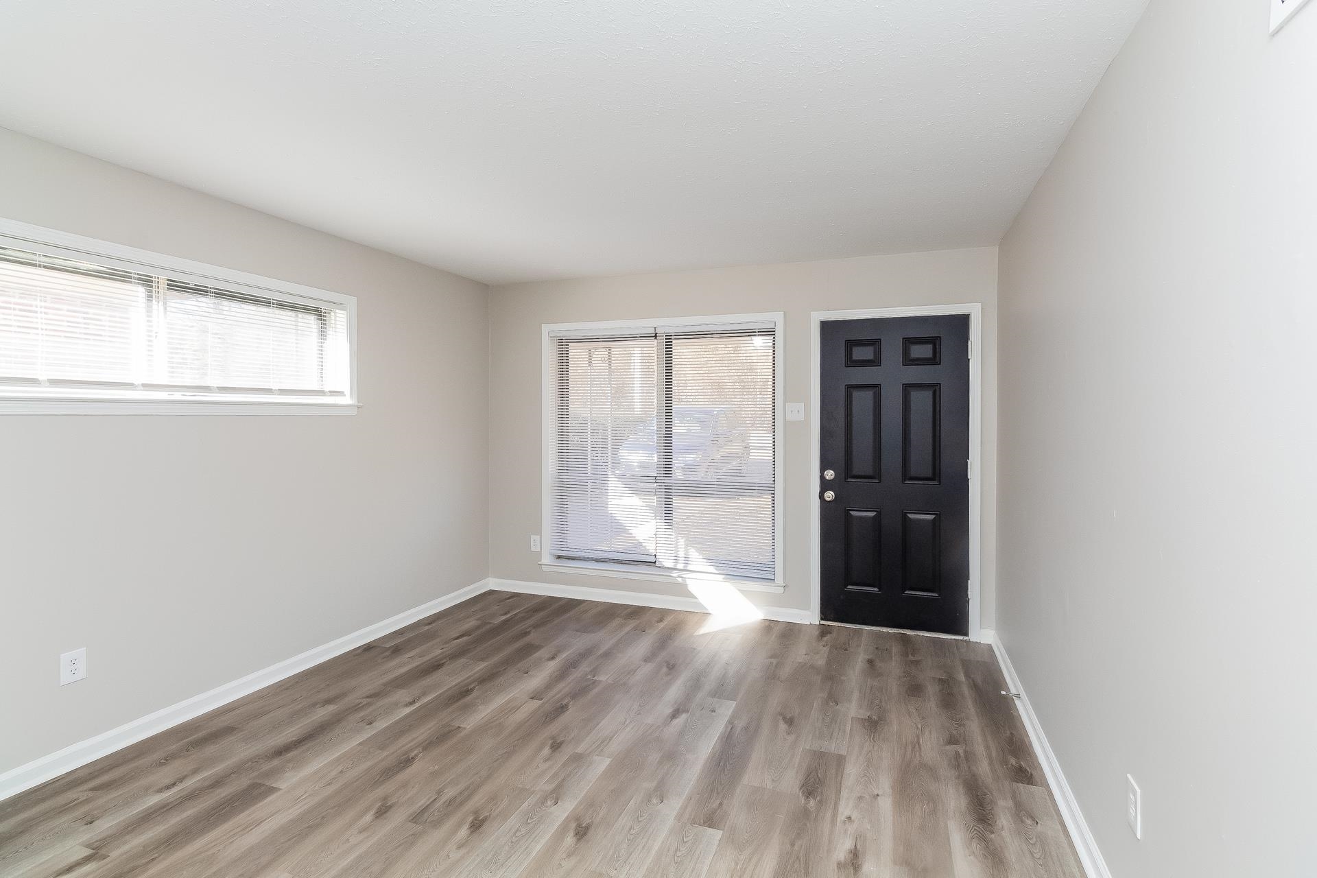 453 Charter Avenue Memphis, TN 38109 - Photo 2 of 16 wooden floor in an empty room with a window