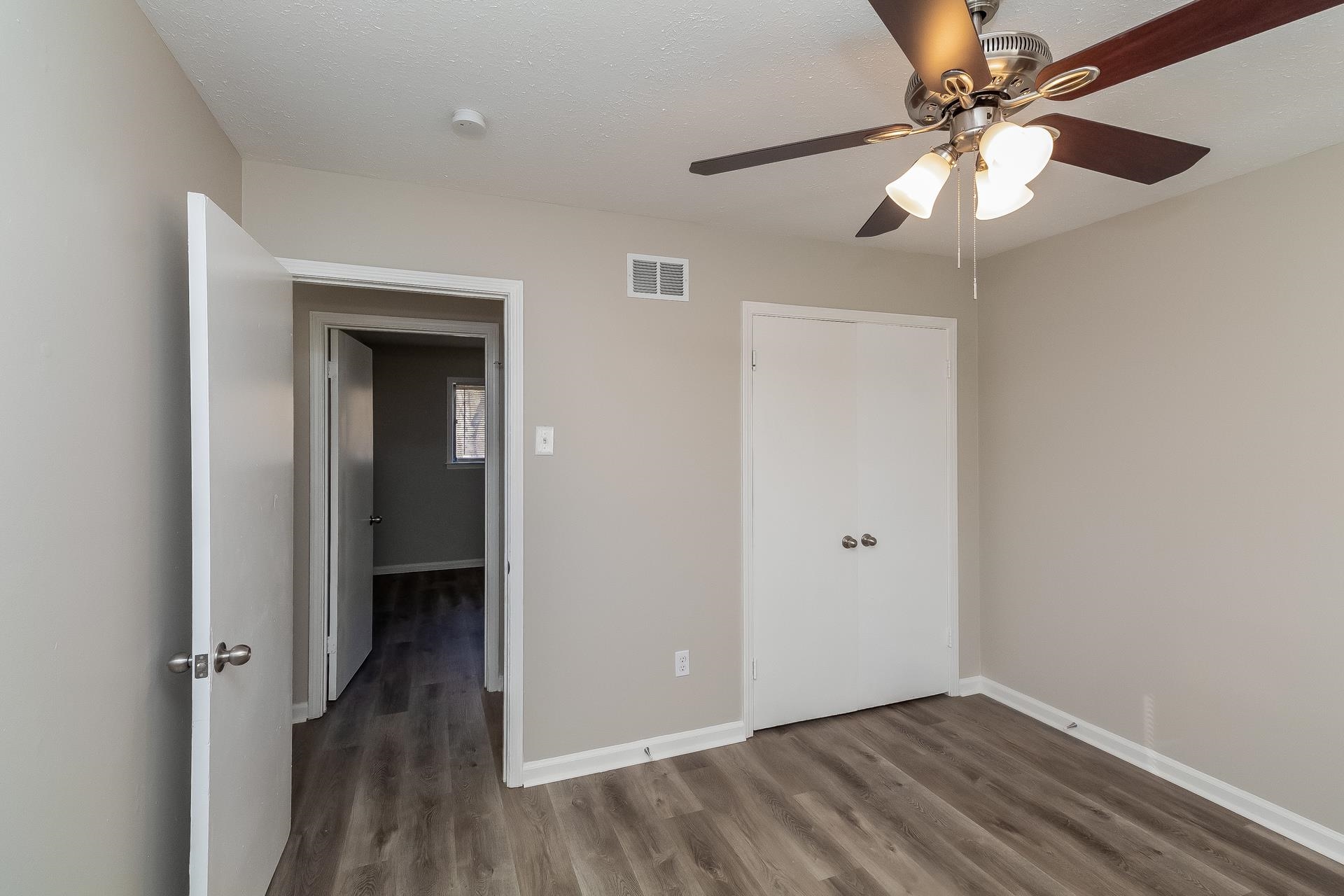 453 Charter Avenue Memphis, TN 38109 - Photo 5 of 16 wooden floor in an empty room with a window