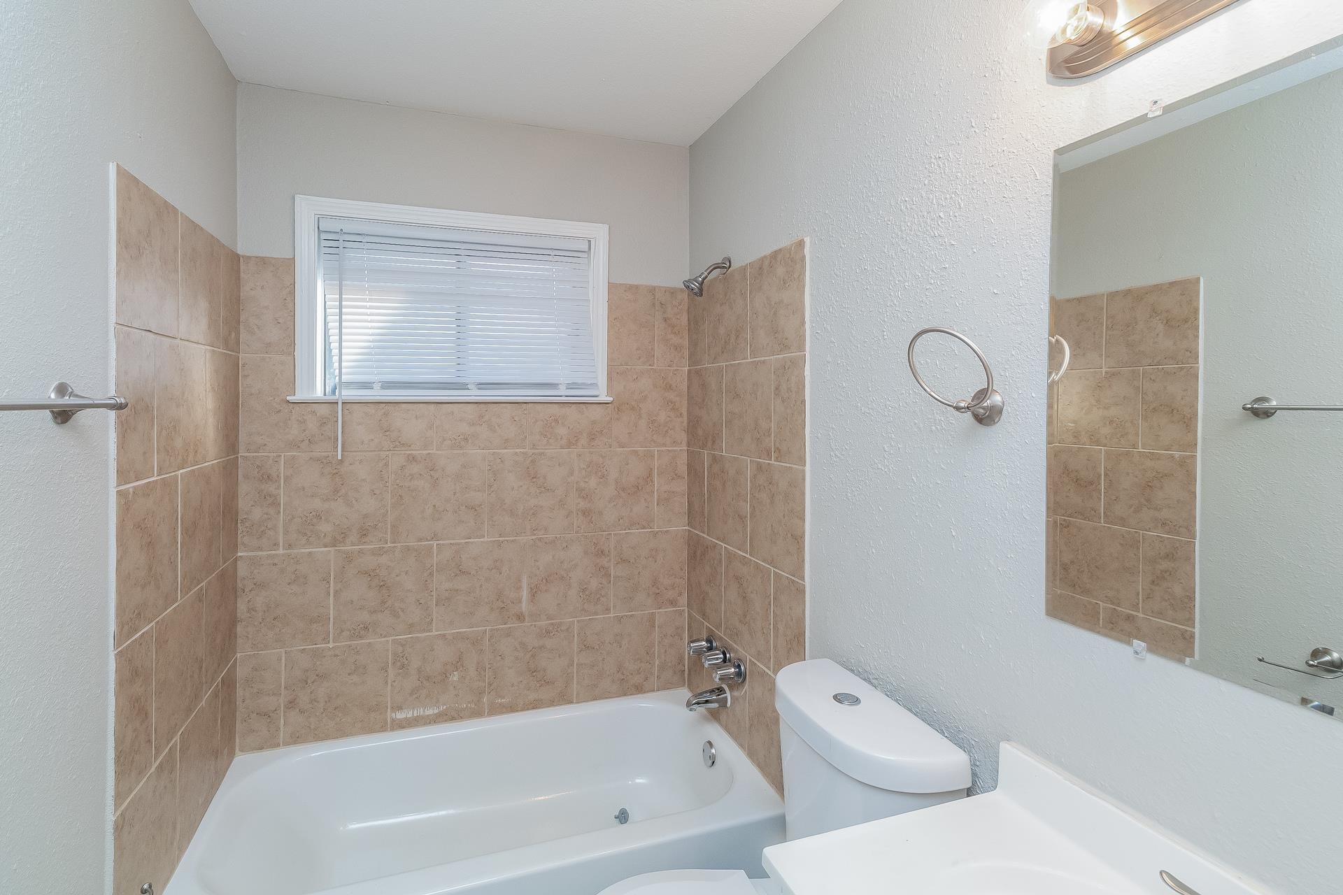 453 Charter Avenue Memphis, TN 38109 - Photo 8 of 16 a bathroom with a toilet and bathtub