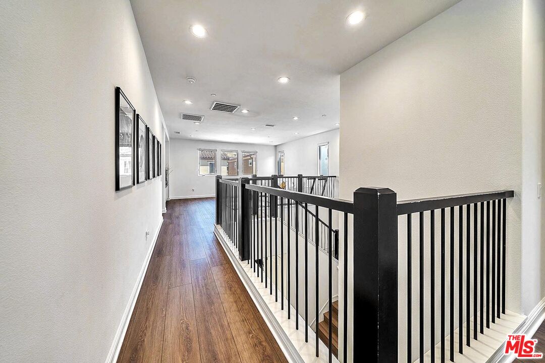 20641 Walnut Circle Porter Ranch, CA 91326 - Photo 23 of 47 a view of a hallway with wooden floor and stairs