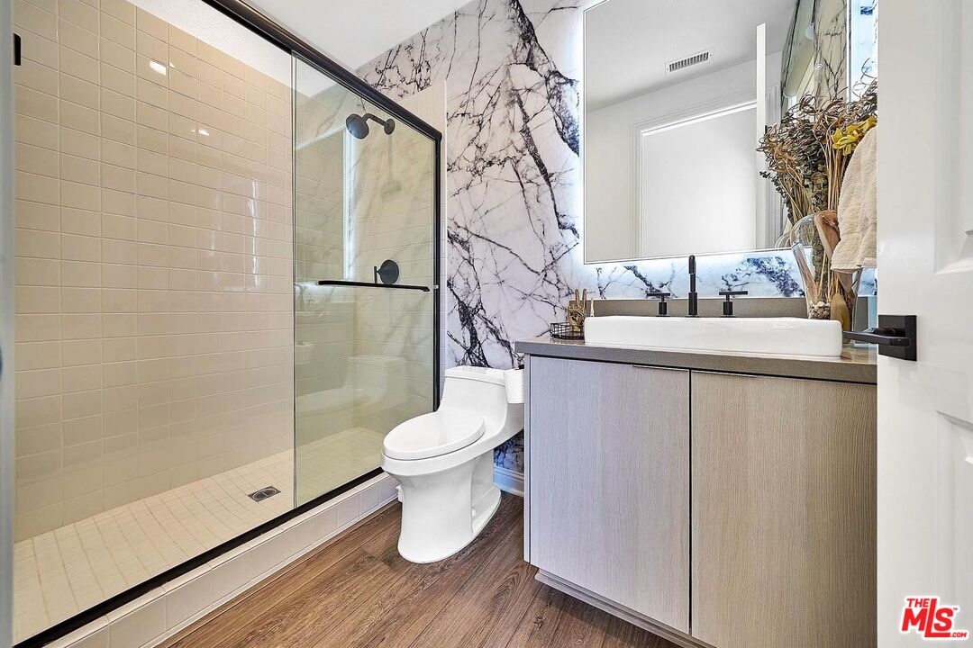 20641 Walnut Circle Porter Ranch, CA 91326 - Photo 28 of 47 a bathroom with a granite countertop sink a toilet and shower