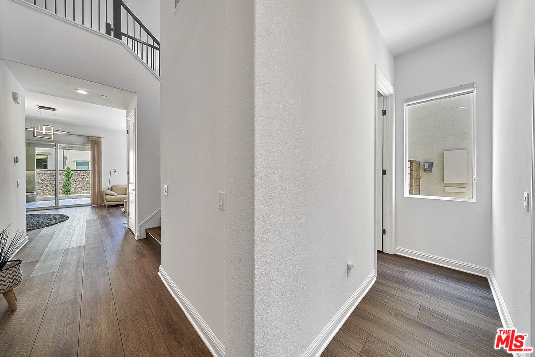 20641 Walnut Circle Porter Ranch, CA 91326 - Photo 5 of 47 a view of a hallway with wooden floor and closet