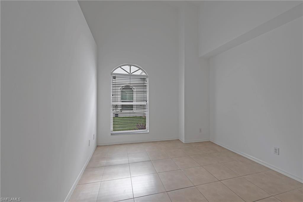 7001 Lone Oak Boulevard Naples, FL 34109 - Photo 12 of 25 an empty room with windows