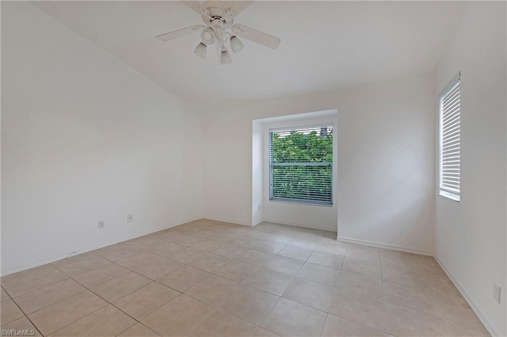 7001 Lone Oak Boulevard Naples, FL 34109 - Photo 13 of 25 an empty room with a window and a fan