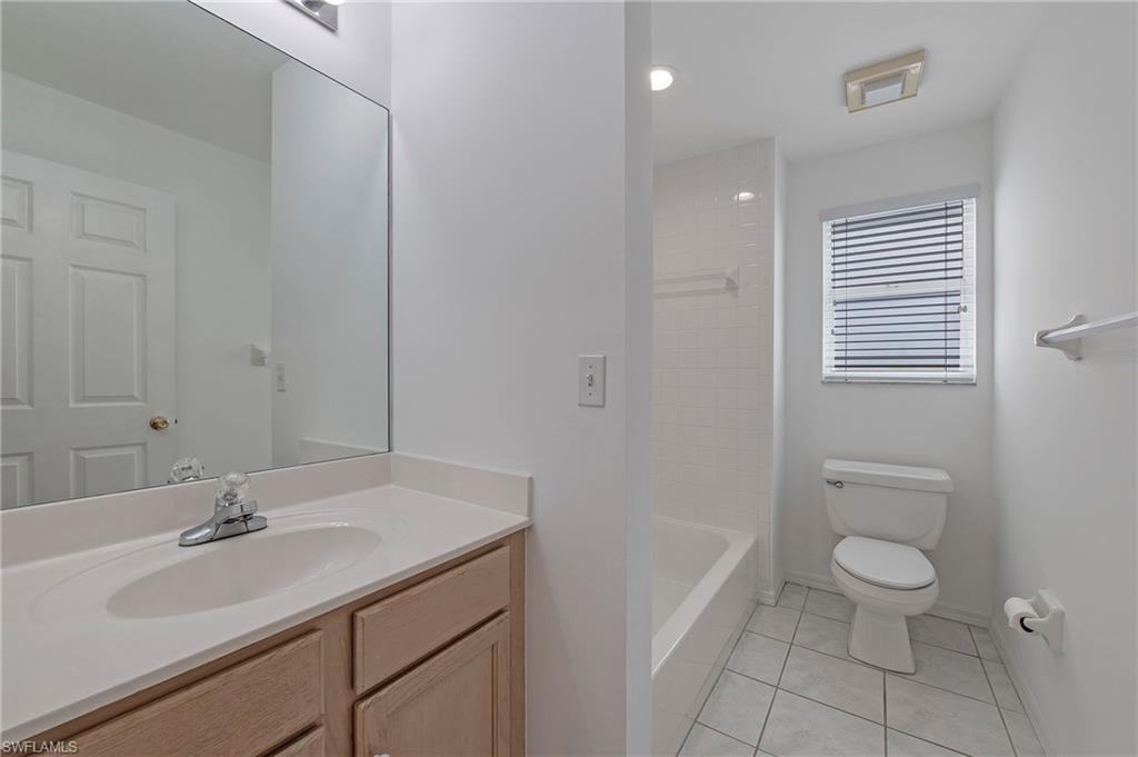 7001 Lone Oak Boulevard Naples, FL 34109 - Photo 18 of 25 a bathroom with a sink a toilet and shower