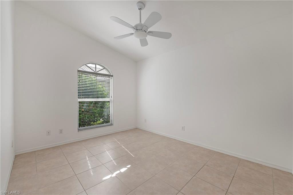 7001 Lone Oak Boulevard Naples, FL 34109 - Photo 20 of 25 an empty room with a window and a fan