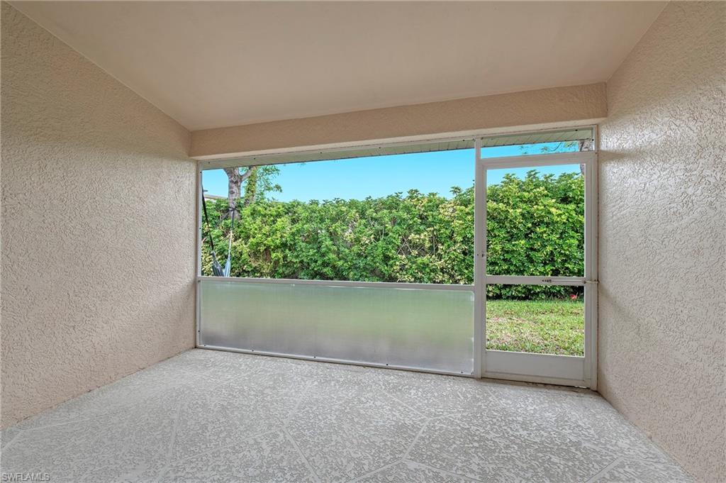 7001 Lone Oak Boulevard Naples, FL 34109 - Photo 21 of 25 a view of empty room with green walls and floor to ceiling window