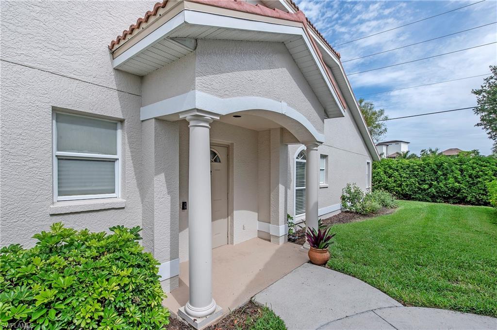 7001 Lone Oak Boulevard Naples, FL 34109 - Photo 3 of 25 a front view of a house with a yard