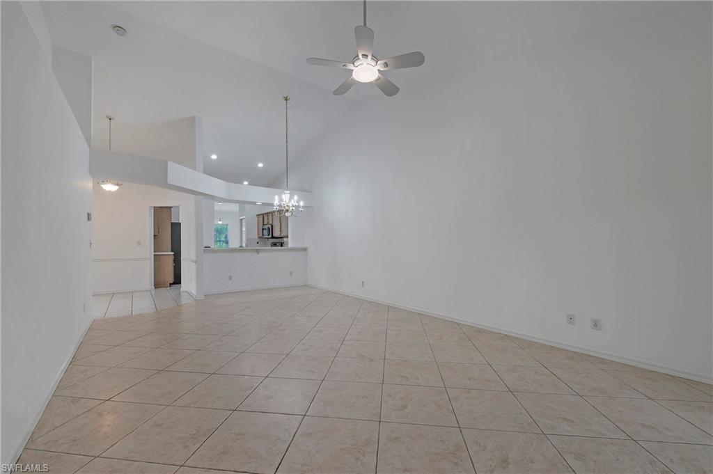 7001 Lone Oak Boulevard Naples, FL 34109 - Photo 5 of 25 an empty room with fan and windows