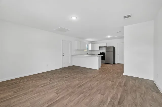 a kitchen with cabinets and stainless steel appliances
