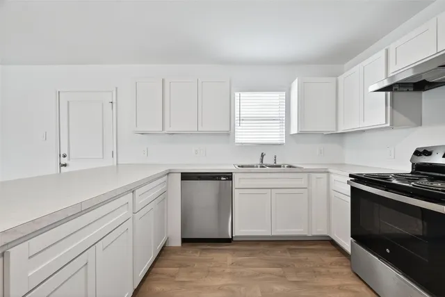 a bathroom with a sink vanity mirror and toilet