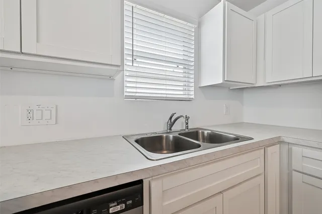 a bathroom with a bathtub shower sink mirror vanity and toilet