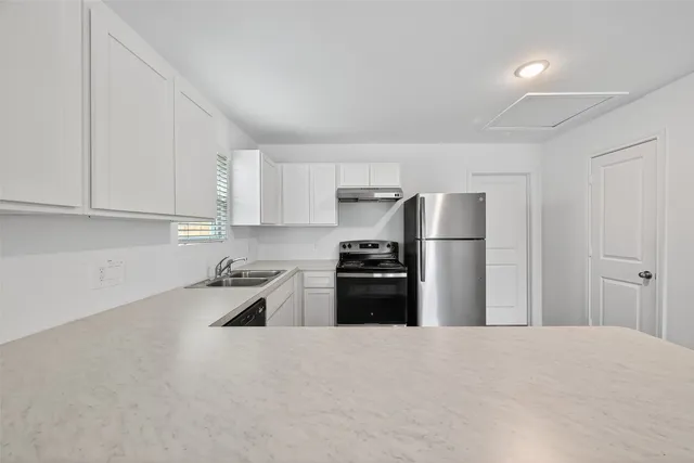 a view of a house with a yard and garage