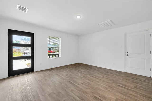 a kitchen with white cabinets stainless steel appliances and sink
