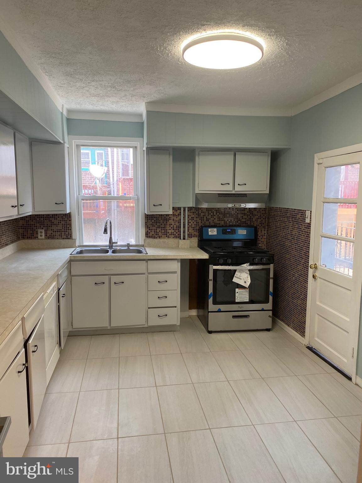 267 Sanford Road Upper Darby, PA 19082 - Photo 9 of 31 a kitchen with stainless steel appliances a stove sink and cabinets