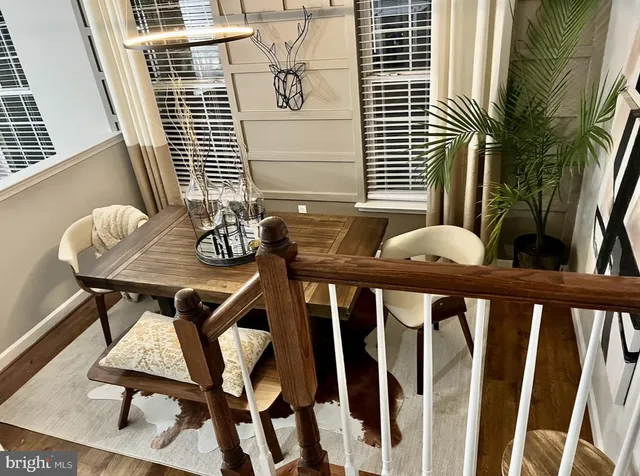 a side view of a chairs and table in the balcony