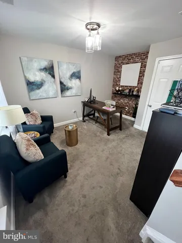 a living room with furniture and a mirror