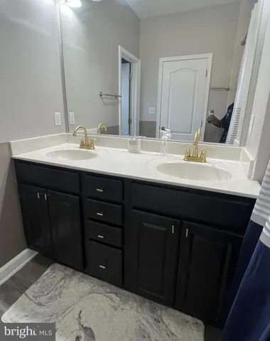 a bathroom with a sink vanity and mirror