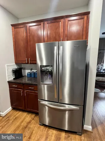 a kitchen with wooden cabinets and stainless steel appliances