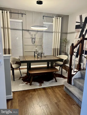a living room with furniture wooden floor and a table