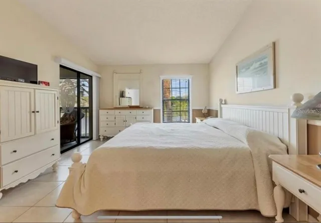 a spacious bedroom with a bed and a cabinets