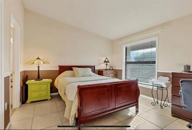 a bedroom with a bed and chair