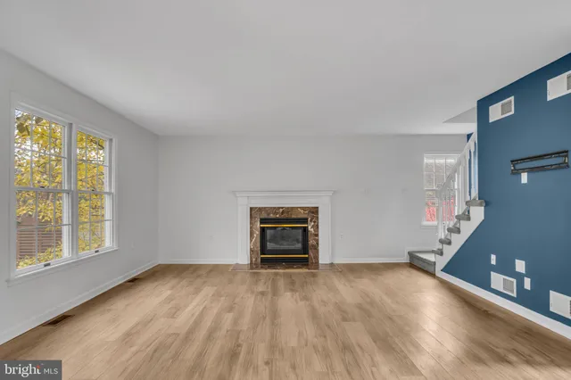 an empty room with window and wooden floor