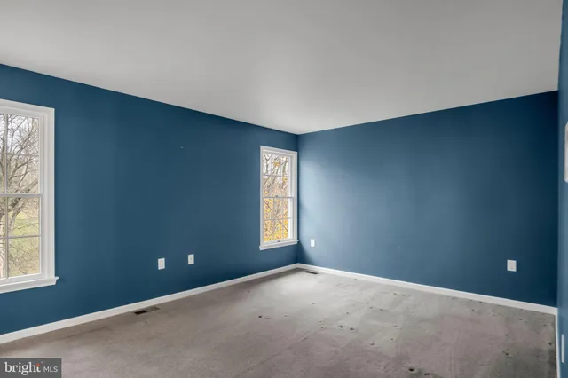a view of an empty room and closet area