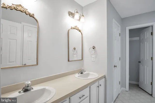 a bathroom with a granite countertop shower a sink and a toilet