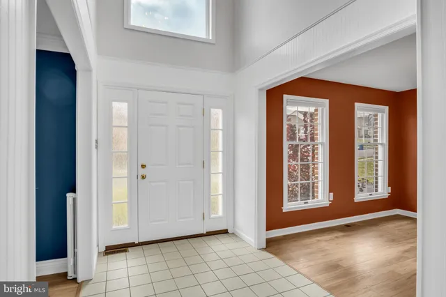 a view of a hallway with wooden floor and entryway