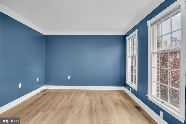 a view of an empty room with glass door and a window