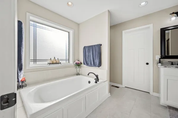 a white bath tub sitting next to a window