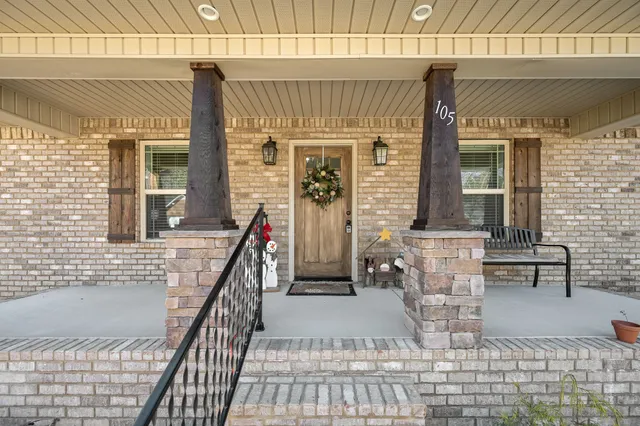 a view of front door of house with stairs
