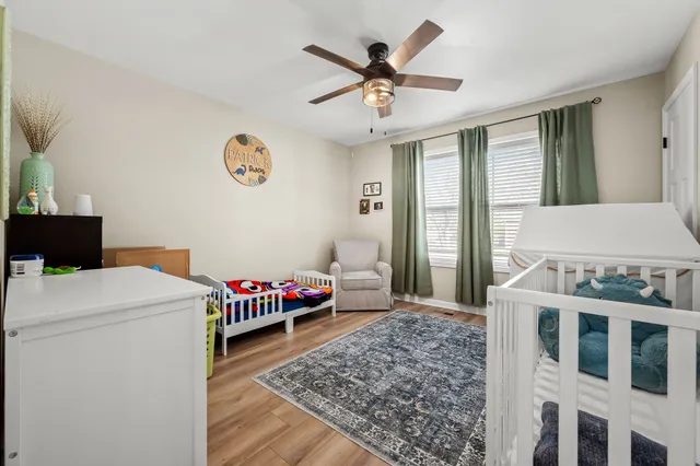 a living room with a bed and a chandelier