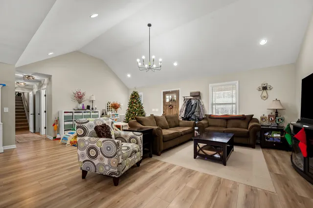 a living room with furniture and a chandelier