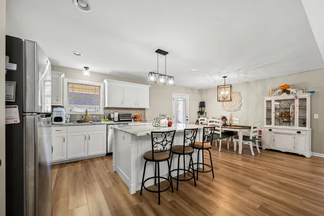 a kitchen with lots of counter top space and dining table
