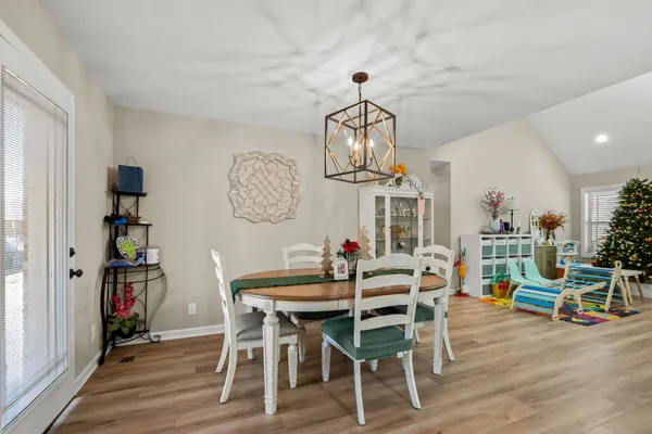 a view of a dining room with furniture and wooden floor