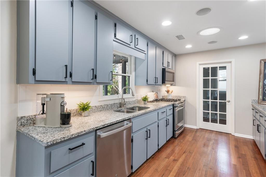 413 Sassafras Road Roswell, GA 30076 - Photo 16 of 67 a kitchen with granite countertop a sink a stove and cabinets