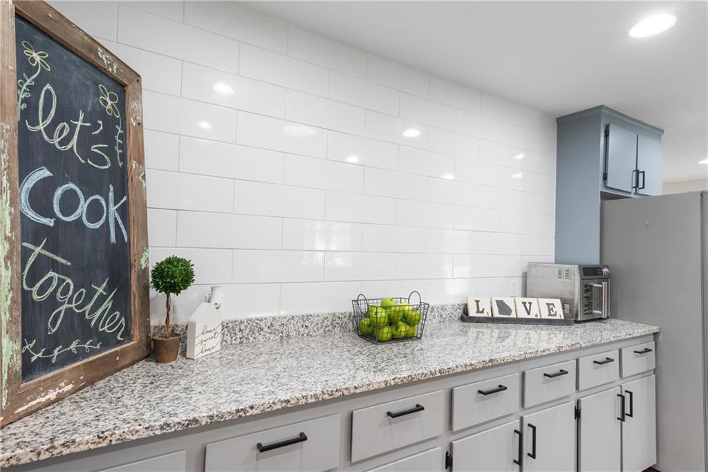 413 Sassafras Road Roswell, GA 30076 - Photo 17 of 67 a kitchen with stainless steel appliances granite countertop a sink and a granite counter tops