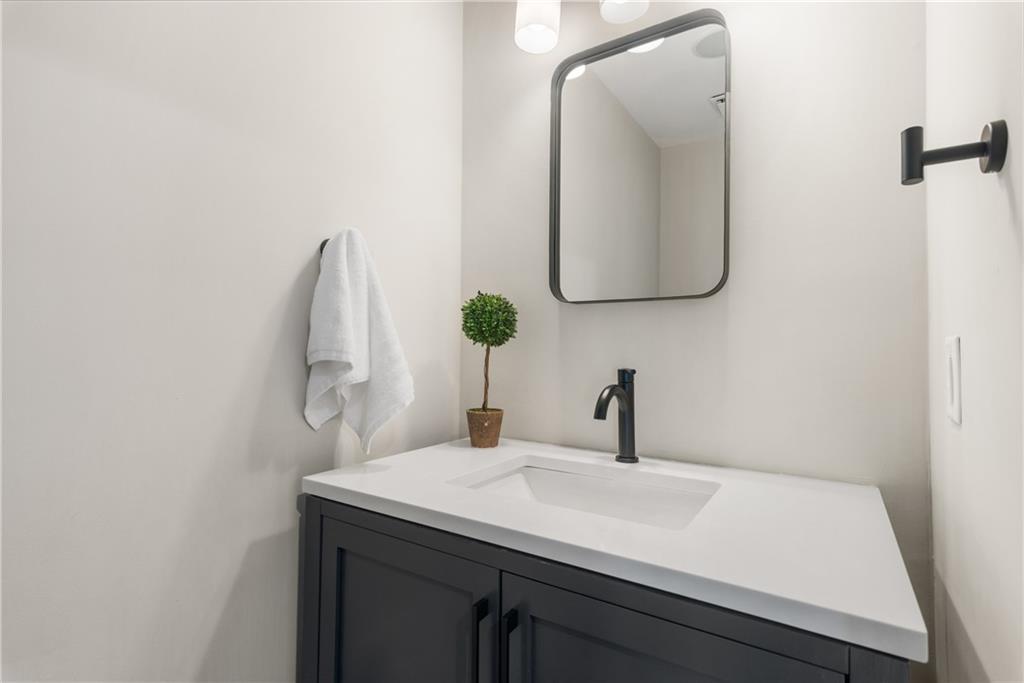 413 Sassafras Road Roswell, GA 30076 - Photo 21 of 67 a bathroom with a sink and a mirror