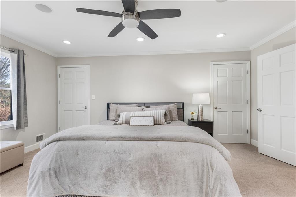 413 Sassafras Road Roswell, GA 30076 - Photo 22 of 67 a bedroom with a large bed and a chandelier