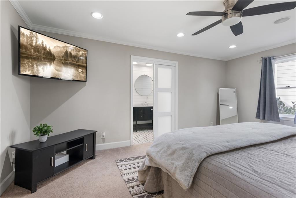 413 Sassafras Road Roswell, GA 30076 - Photo 24 of 67 a bedroom with a bed and a chandelier