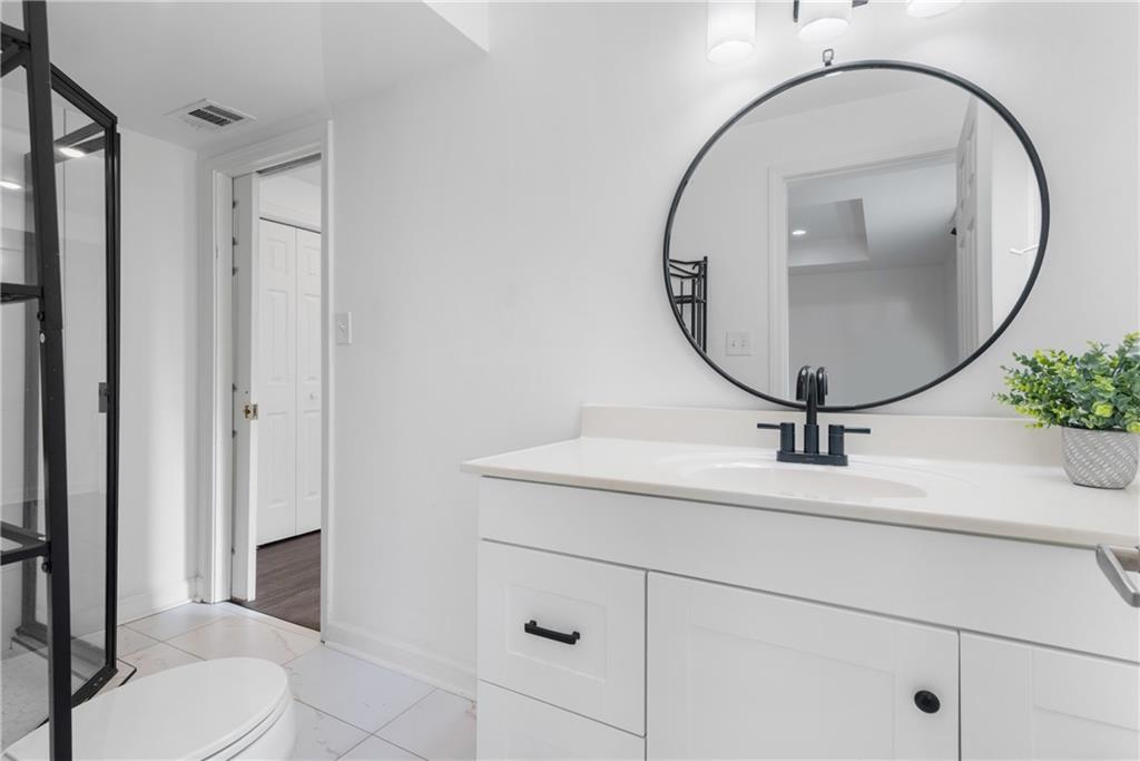 413 Sassafras Road Roswell, GA 30076 - Photo 41 of 67 a bathroom with a sink and a mirror