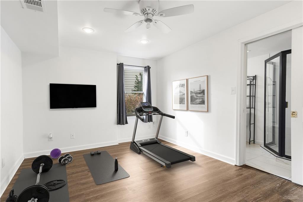 413 Sassafras Road Roswell, GA 30076 - Photo 43 of 67 a room with gym equipment and a flat screen tv