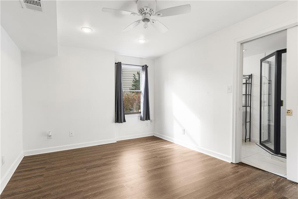 413 Sassafras Road Roswell, GA 30076 - Photo 44 of 67 an empty room with wooden floor and windows