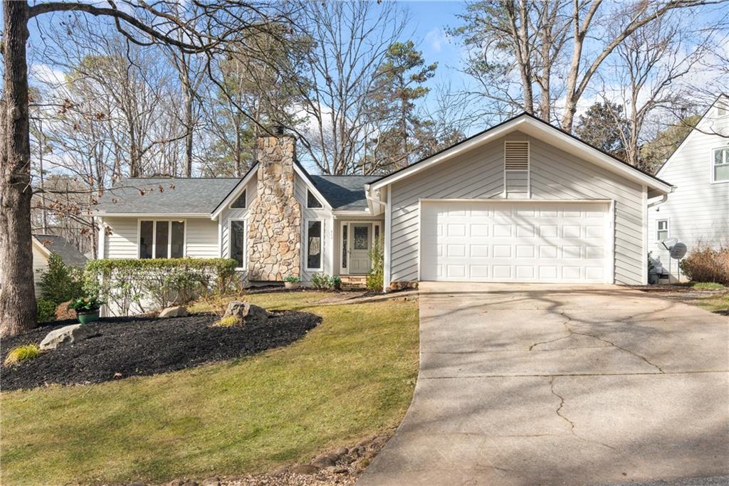413 Sassafras Road Roswell, GA 30076 - Photo 65 of 67 a front view of a house with a yard and garage
