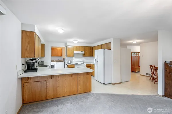 a kitchen with a sink and refrigerator