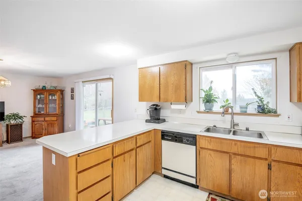 a kitchen with sink a window and cabinets