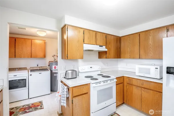 a kitchen with a sink a stove and cabinets